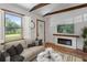 Cozy living room with a modern fireplace, comfortable seating, and natural light offers relaxation at 2963 Alabama Dr, North Charleston, SC 29405