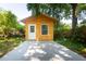 Exterior of a small shed with a modern platform, a window, and a door surrounded by greenery at 2963 Alabama Dr, North Charleston, SC 29405
