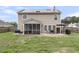 View of the home's rear exterior showing the patio, yard, solar panels, and siding at 301 Edenton Rd, Goose Creek, SC 29445