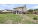 Wide view of backyard with screened patio, dining set, solar panels, and mature trees at 301 Edenton Rd, Goose Creek, SC 29445