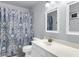 Bright bathroom with blue patterned shower curtain, white vanity, and modern fixtures at 301 Edenton Rd, Goose Creek, SC 29445