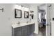 Bright bathroom featuring double sinks, grey vanity, framed mirrors and decor shelving at 301 Edenton Rd, Goose Creek, SC 29445