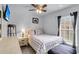 Comfortable bedroom with ceiling fan, neutral walls, and a large window letting in natural light at 301 Edenton Rd, Goose Creek, SC 29445
