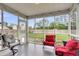 A cozy screened-in porch offers an outdoor space for relaxation with comfortable seating and an overhead light at 301 Edenton Rd, Goose Creek, SC 29445