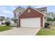 Residential home with a two-car garage and charming covered porch at 301 Edenton Rd, Goose Creek, SC 29445