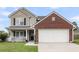Charming two-story home featuring a brick accent garage and inviting front porch at 301 Edenton Rd, Goose Creek, SC 29445