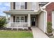 Home entrance with a welcoming porch, dark front door, and tidy landscaping at 301 Edenton Rd, Goose Creek, SC 29445
