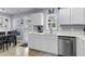 Kitchen with white cabinets, stainless steel appliances, tile floors, view of patio, and lots of natural light at 301 Edenton Rd, Goose Creek, SC 29445