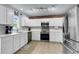 Gourmet kitchen features white cabinets, stainless steel appliances, granite countertops and brick accent wall at 301 Edenton Rd, Goose Creek, SC 29445