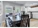 Eat-in kitchen with tile floors, white cabinets, stainless steel appliances, and large table with bench seating at 301 Edenton Rd, Goose Creek, SC 29445