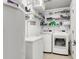 Laundry room with white washer, dryer, shelving, and storage, equipped for convenience and organization at 301 Edenton Rd, Goose Creek, SC 29445