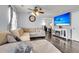 Inviting living room with large TV, ceiling fan, and hardwood flooring at 301 Edenton Rd, Goose Creek, SC 29445
