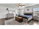 Bright main bedroom features hardwood floors, a ceiling fan, and modern furnishings, with an ensuite bathroom entrance at 301 Edenton Rd, Goose Creek, SC 29445