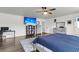The spacious main bedroom features wood-look flooring, a TV, a ceiling fan and provides an entry into the ensuite bathroom at 301 Edenton Rd, Goose Creek, SC 29445