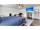 A cozy main bedroom features hardwood floors, and is equipped with a ceiling fan and a modern entertainment system at 301 Edenton Rd, Goose Creek, SC 29445