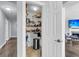 Spacious walk-in pantry with wire shelving, adjacent to living room with fireplace and television at 301 Edenton Rd, Goose Creek, SC 29445