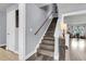 Elegant staircase with wooden stairs and railing leading to the upper level, showcasing modern design at 301 Edenton Rd, Goose Creek, SC 29445