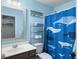 Bathroom with blue walls, whale shower curtain, silver framed mirror and beach decor at 301 Mondo Ct, Summerville, SC 29486