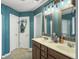 Bathroom with double sinks, warm paint, tile flooring and walk-in shower at 301 Mondo Ct, Summerville, SC 29486