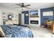 Large primary bedroom with a ceiling fan, a tv over an electric fireplace, and an ensuite bathroom at 301 Mondo Ct, Summerville, SC 29486