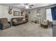 Spacious bonus room with neutral carpeting, a brown leather sofa, and nautical themed decor at 301 Mondo Ct, Summerville, SC 29486