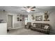 Spacious bonus room with neutral carpeting, a brown leather sofa, nautical themed decor and ceiling fan at 301 Mondo Ct, Summerville, SC 29486