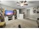 Spacious bonus room with neutral carpeting, TV, sliding barn door style cabinets, and ceiling fan at 301 Mondo Ct, Summerville, SC 29486