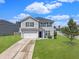 Charming two-story home features a well-maintained lawn and a two-car garage at 301 Mondo Ct, Summerville, SC 29486