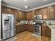 Well-lit kitchen with wood flooring, stainless steel appliances, granite countertops, and wooden cabinets at 301 Mondo Ct, Summerville, SC 29486