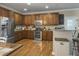 Well-lit kitchen with wood flooring, stainless steel appliances, granite countertops, and wooden cabinets at 301 Mondo Ct, Summerville, SC 29486
