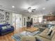 Open living room flows into the kitchen and features wood flooring and a ceiling fan at 301 Mondo Ct, Summerville, SC 29486