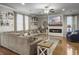 Spacious living room with a large sectional sofa, fireplace, ceiling fan, and multiple windows at 301 Mondo Ct, Summerville, SC 29486