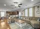Open living room flows into the kitchen and features wood flooring and a ceiling fan at 301 Mondo Ct, Summerville, SC 29486