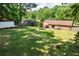 Aerial view of a home featuring a spacious backyard with patio and lush greenery at 305 Forest Cir, Summerville, SC 29483