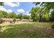 A vast backyard area with a brick house, seating, a storage shed, and a well-maintained green lawn at 305 Forest Cir, Summerville, SC 29483