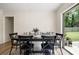Bright dining area featuring a modern table, bench seating, and a view of the backyard at 305 Forest Cir, Summerville, SC 29483
