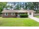 Charming brick home with well-maintained lawn, light blue shutters, and mature trees at 305 Forest Cir, Summerville, SC 29483