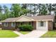 Charming brick home featuring a manicured lawn, brickwork and well-kept landscaping at 305 Forest Cir, Summerville, SC 29483