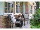 Relaxing porch with two chairs and a small table, showcasing the home's exterior at 305 Forest Cir, Summerville, SC 29483