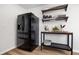 Kitchen area featuring a black refrigerator and a table with shelves, providing ample storage space at 305 Forest Cir, Summerville, SC 29483