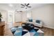 Comfortable living room with a modern sofa, area rug and ceiling fans at 305 Forest Cir, Summerville, SC 29483