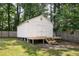 A spacious storage shed in the backyard with concrete base supports and newly constructed wood stairs at 305 Forest Cir, Summerville, SC 29483