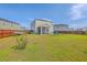 Large backyard with a view of the screened porch and lawn leading to a wood fence at 307 Fox Gap Rd, Summerville, SC 29486