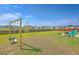 Spacious backyard with a swing set, fire pit, and lawn extending to a wood fence at 307 Fox Gap Rd, Summerville, SC 29486