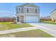 Two-story home with a manicured lawn, front porch, and a two-car garage at 307 Fox Gap Rd, Summerville, SC 29486