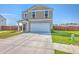 Charming two-story home showcasing a well-maintained lawn and a two-car garage at 307 Fox Gap Rd, Summerville, SC 29486