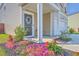 Charming front porch with flowerbeds, neutral siding, and a view of the garage and front yard at 307 Fox Gap Rd, Summerville, SC 29486