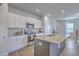 Spacious kitchen features modern appliances, a center island with a sink, granite countertops, and white cabinets at 307 Fox Gap Rd, Summerville, SC 29486