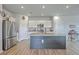 Bright, open kitchen with stainless steel appliances, granite countertops, and an island with bar seating at 307 Fox Gap Rd, Summerville, SC 29486