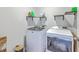 Functional laundry room with modern washer and dryer units and practical shelving for supplies at 307 Fox Gap Rd, Summerville, SC 29486